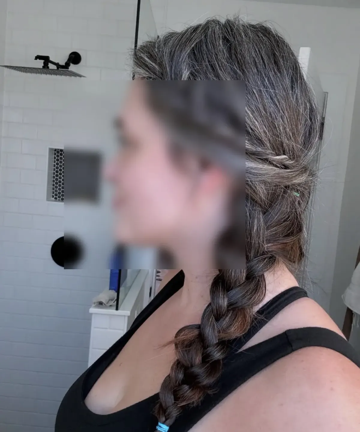 Person with braided gray and brown hair in a bathroom for a guide to comparing kink-aware dating app options Person with braided gray and brown hair in a bathroom for a guide to comparing kink-aware dating app options