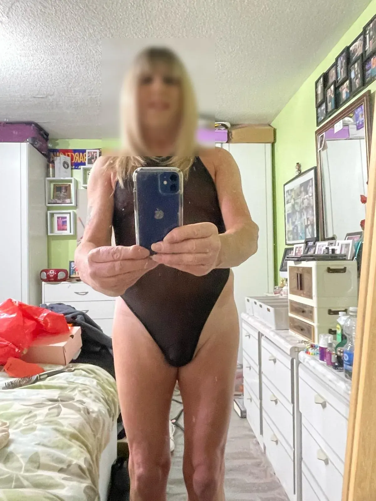 Person in a dark one-piece swimsuit taking a mirror selfie in a bedroom for kink dating app review context Person in a dark one-piece swimsuit taking a mirror selfie in a bedroom for kink dating app review context